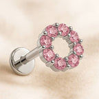 earring with pink gemstones on a beige background
