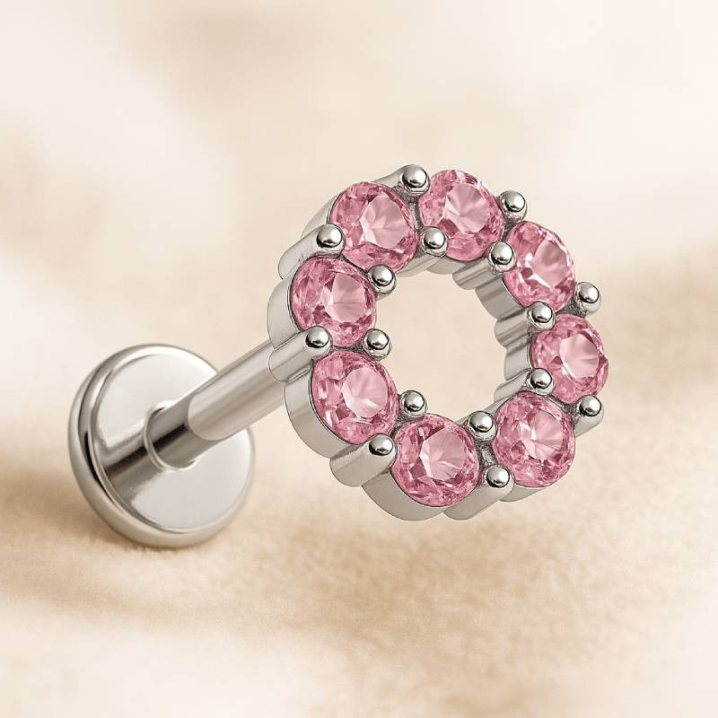 earring with pink gemstones on a beige background