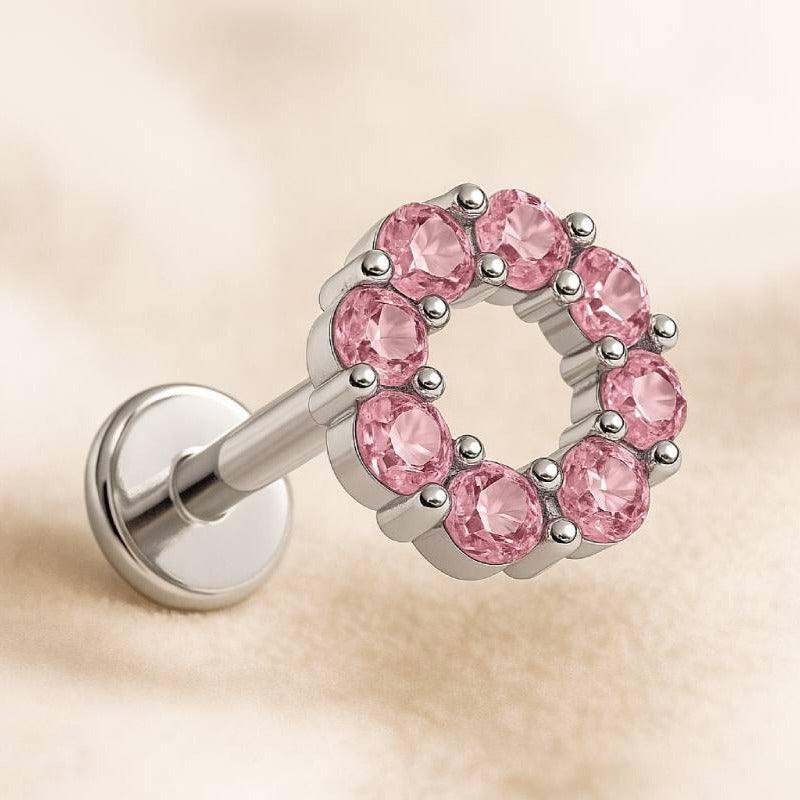 earring with pink gemstones on a beige background