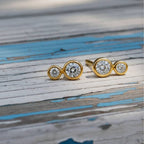 earrings with clear gemstones on a wood background