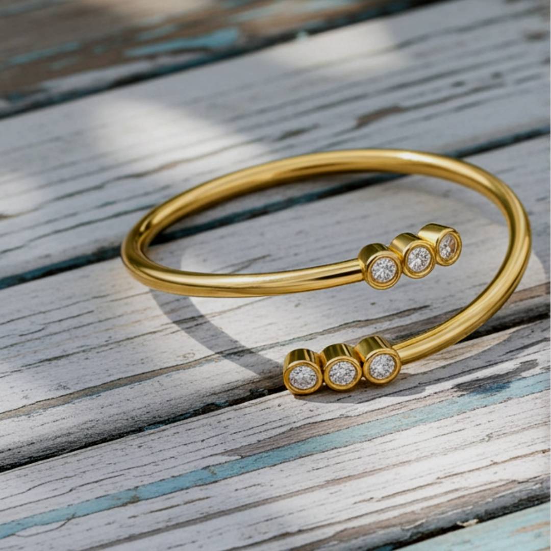 Gold ring with diamond accents on a soft wood background