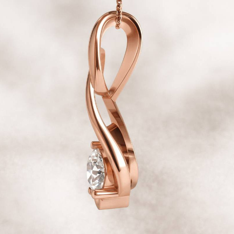 Rose gold infinity pendant with a diamond on a soft beige background