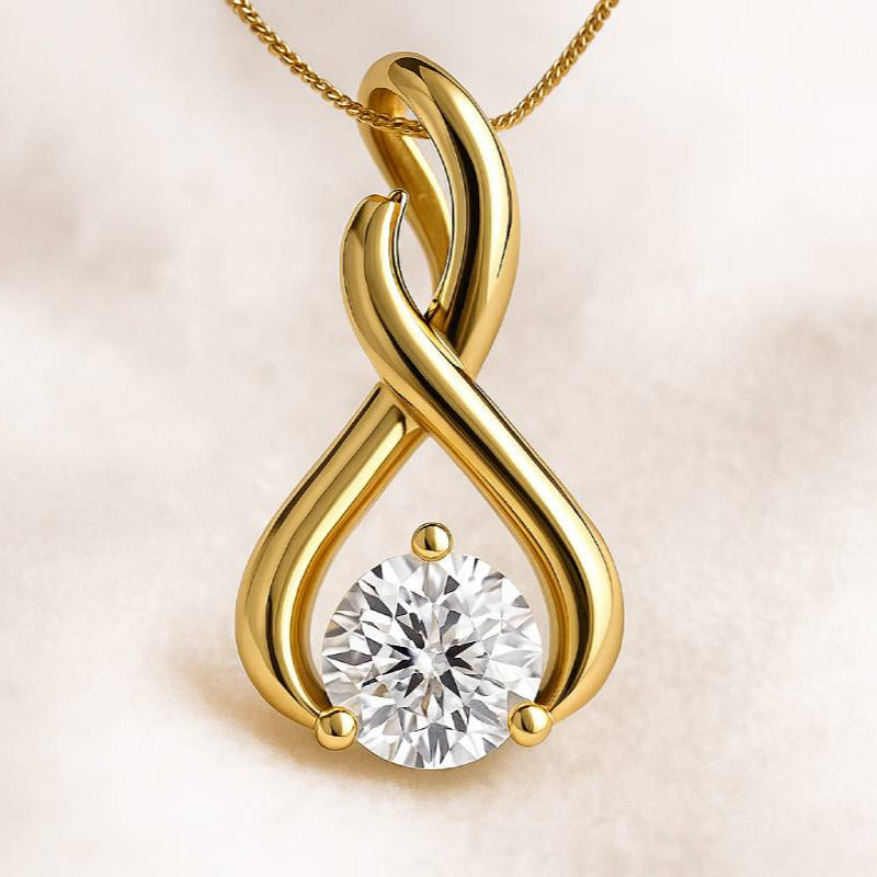 Gold infinity pendant with a diamond on a beige background
