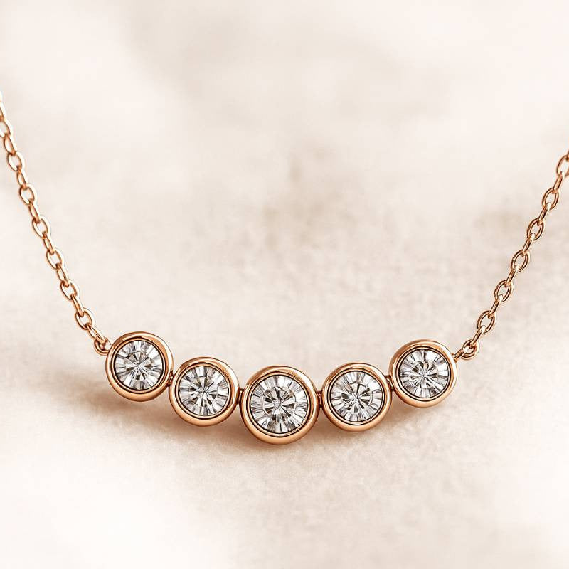 Rose gold necklace with diamond beads on a light beige background