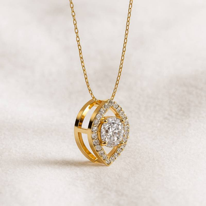 Gold necklace with a heart-shaped pendant on a light background