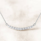necklace with small diamonds on a light pink background