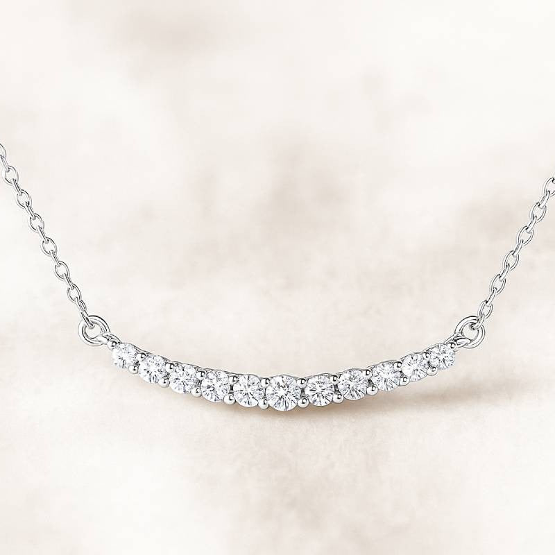 necklace with small diamonds on a light pink background