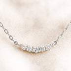 necklace with small diamonds on a beige background