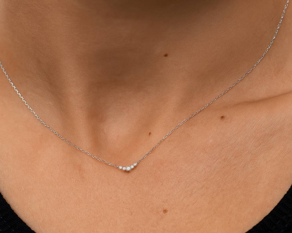 Close-up of a silver necklace on a person's neck