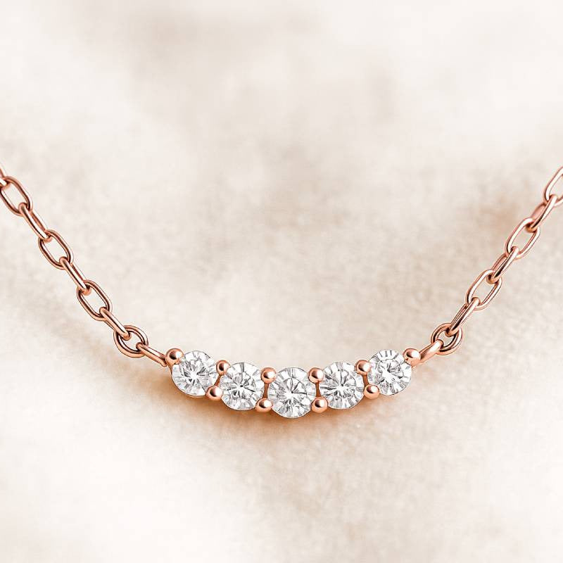 Rose gold necklace with diamonds on a soft beige background