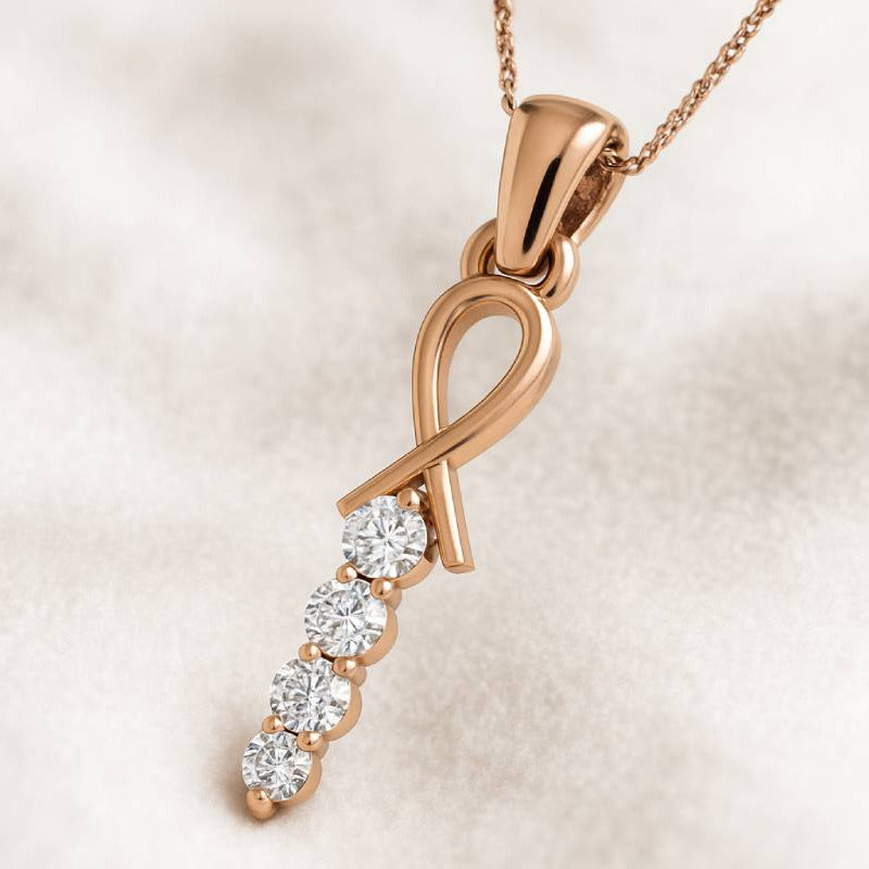 Rose gold pendant with diamonds on a beige background