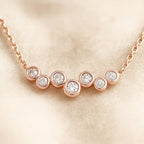 Rose gold necklace with diamonds on a beige background