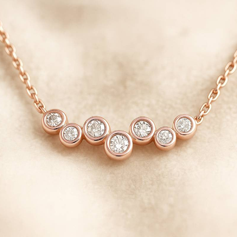 Rose gold necklace with diamonds on a beige background