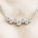 necklace with round diamonds on a beige background