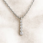Diamond necklace on a light pink background