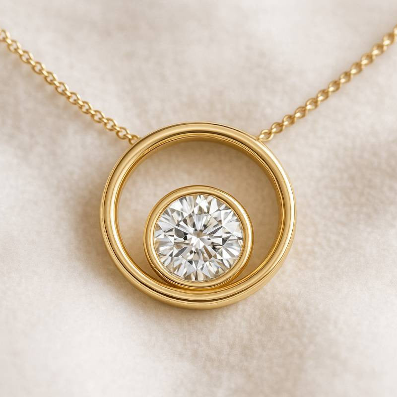 Gold necklace with a diamond pendant on a beige background