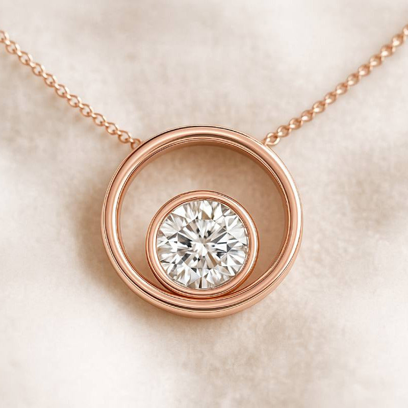 Rose gold necklace with a diamond pendant on a soft beige background