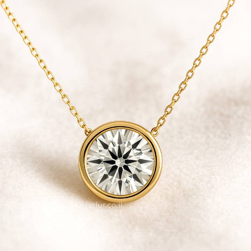 Gold necklace with a diamond pendant on a light background