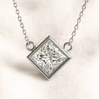  necklace with a square-cut diamond pendant on a light background
