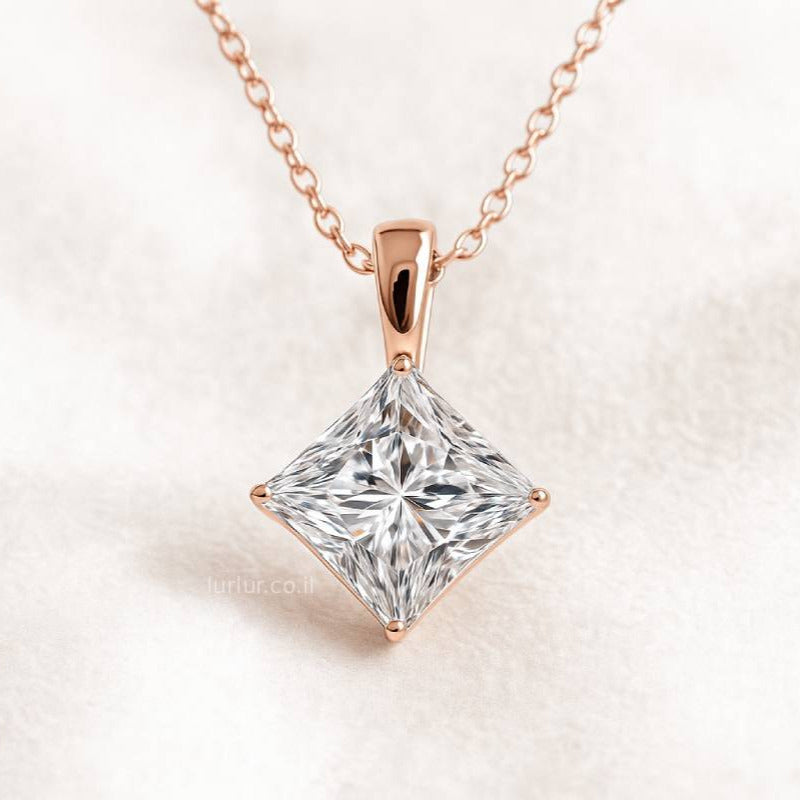 Rose gold necklace with a square-cut diamond pendant on a light background