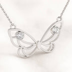 gold butterfly necklace with gemstones on a white background