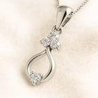  pendant with diamond accents on a beige background