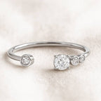 gold ring with diamonds on a light beige background
