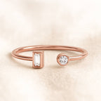 Rose gold ring with diamond accents on a beige background