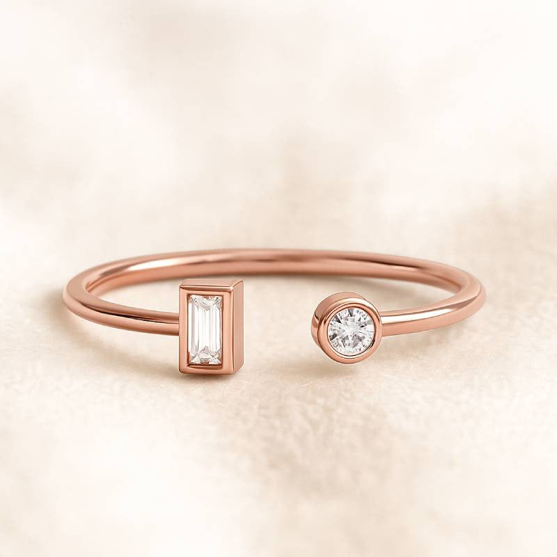 Rose gold ring with diamond accents on a beige background