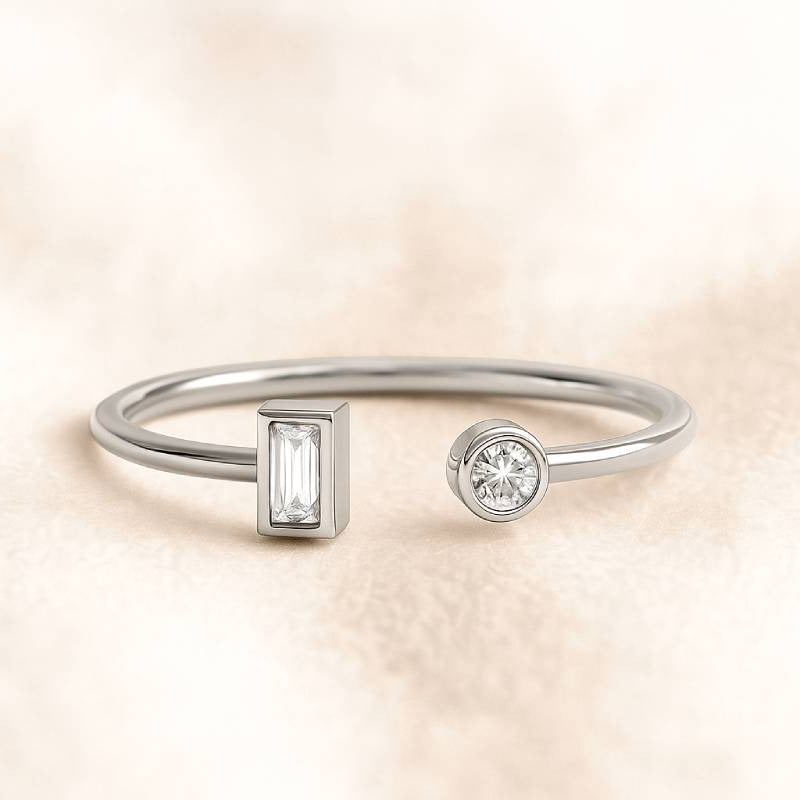 gold ring with two diamond charms on a beige background