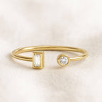 Gold ring with diamond accents on a light beige background