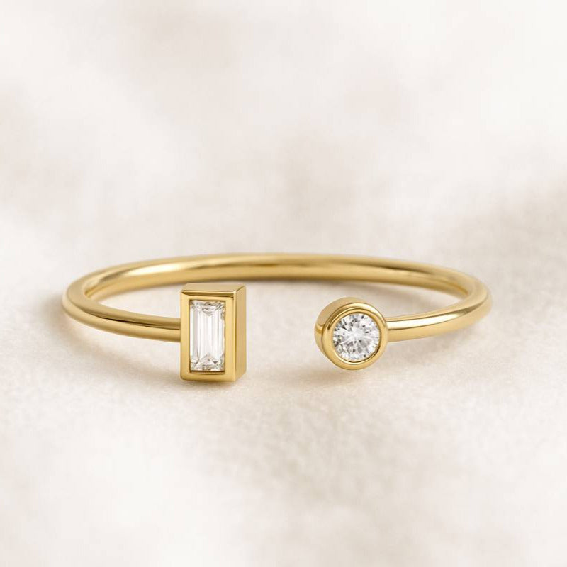 Gold ring with diamond accents on a light beige background