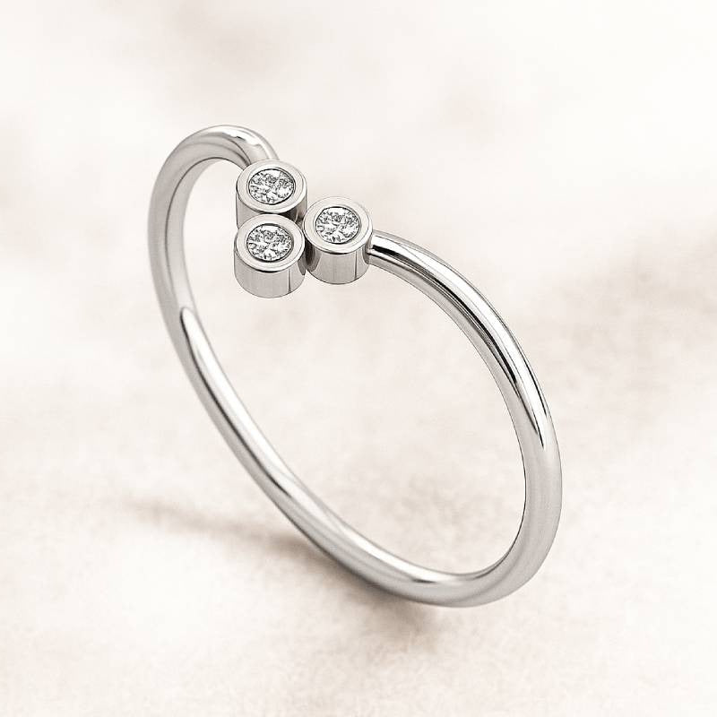 gold ring with three small diamonds on a light background