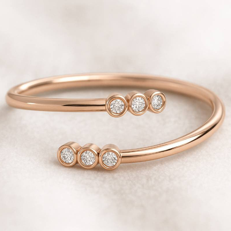 Rose gold ring with embedded diamonds on a light background