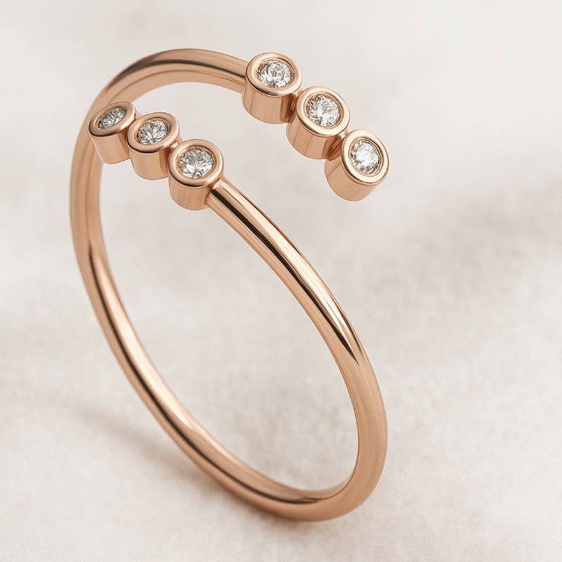 Rose gold ring with diamonds on a light background