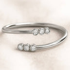 ring with diamond accents on a light beige background