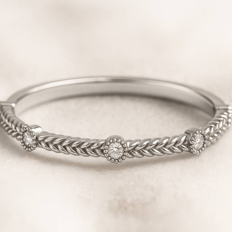 gold ring with intricate design on a light beige background