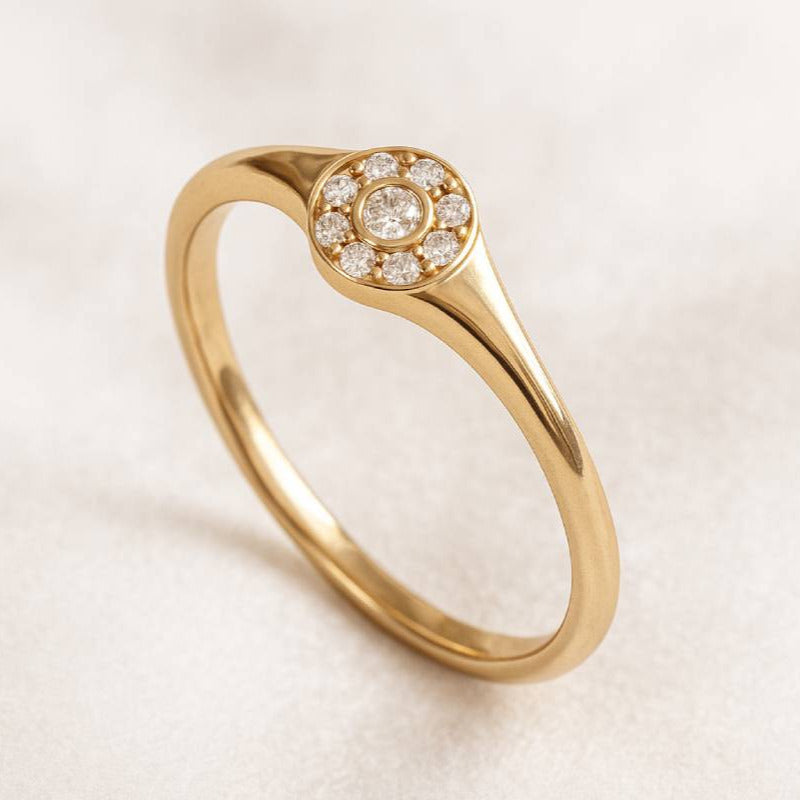 Gold ring with small diamonds on a light background