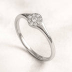 Gold ring with small diamonds on a light background