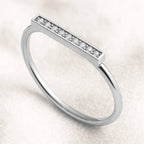 Gold ring with small diamonds on a light background