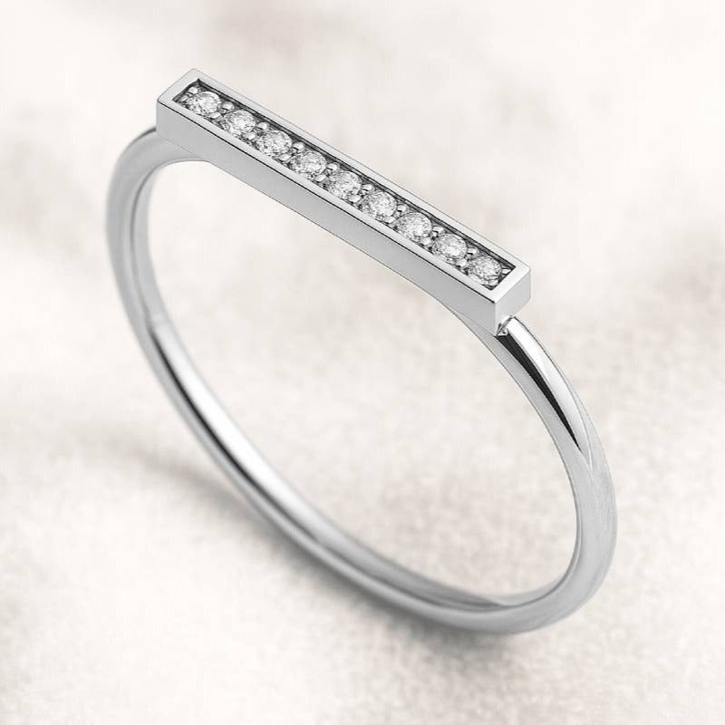 Gold ring with small diamonds on a light background