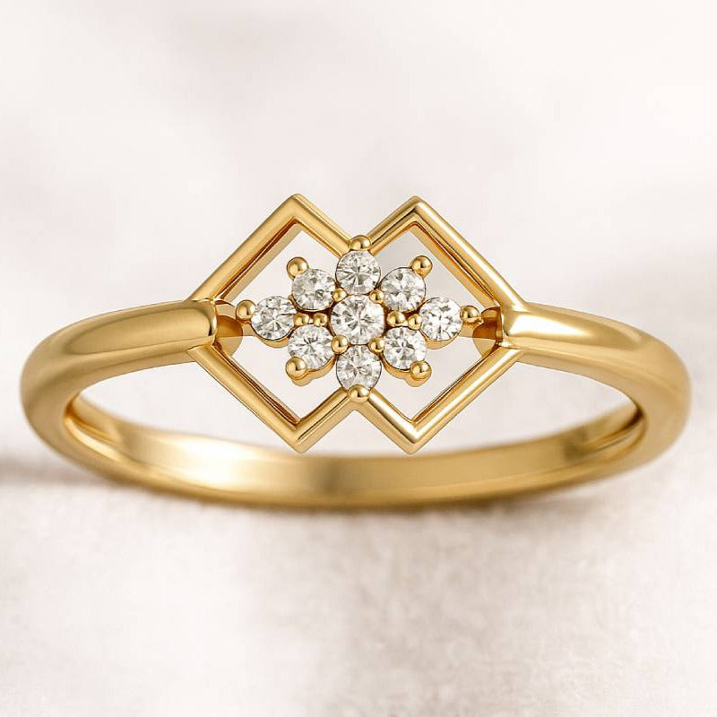 Gold ring with diamond flower design on a light background