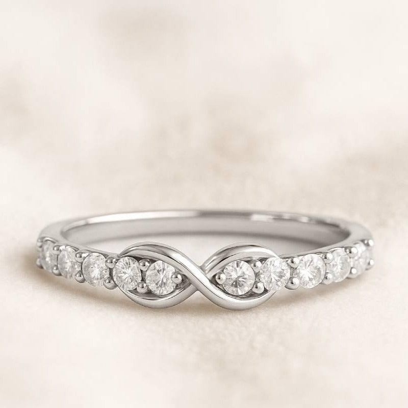 Gold ring with diamonds on a light beige background