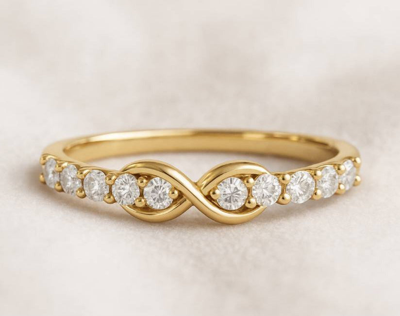 Gold ring with diamonds on a beige background