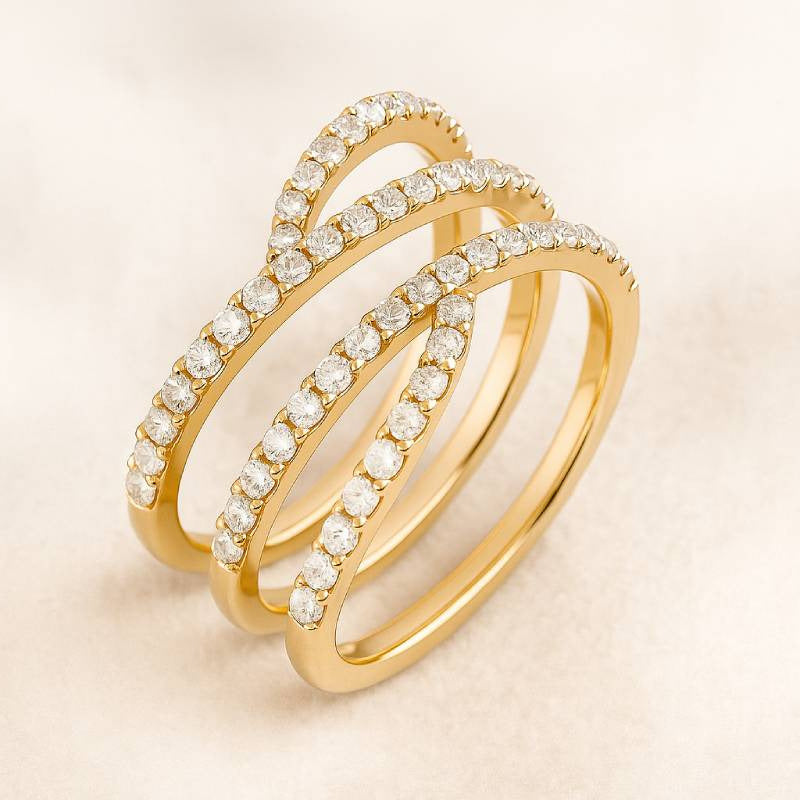 Gold ring with diamond accents on a beige background