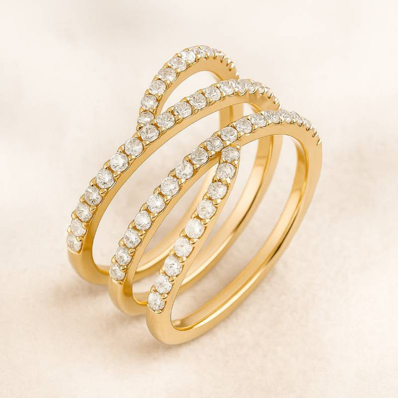 Gold ring with diamond accents on a beige background