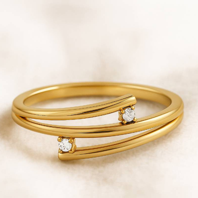 Gold ring with diamonds on a beige background