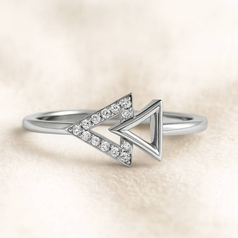 Gold ring with diamond accents on a beige background