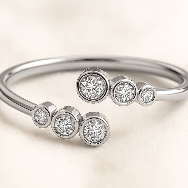 Gold ring with small diamonds on a light beige background