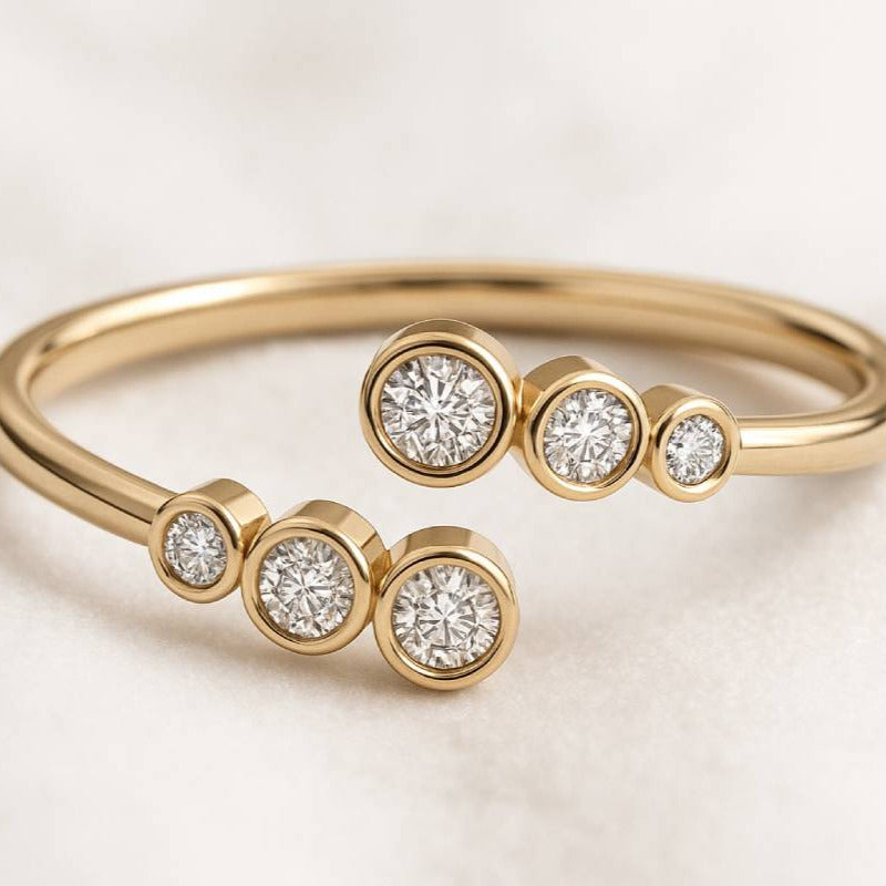 Gold ring with diamond accents on a light background